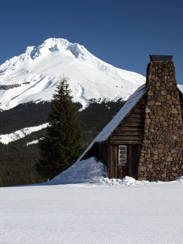 Large floodlights illuminate the upper bowl and lower ski run as skiers and boarders enjoy night skiing at Mt. Hood Skibowl