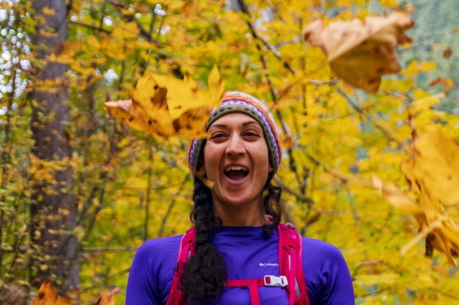 tossing leaves during fall hike