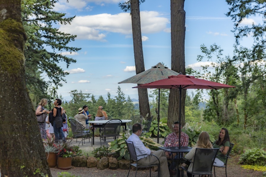 People sitting outdoors at Campbell Lane Winery before a Field and Vine Dinner