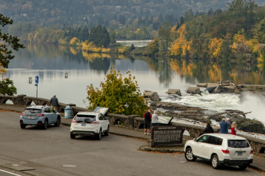 Willamette Falls overlook with cars and fall trees from the Museum of the Oregon Territory in Oregon City