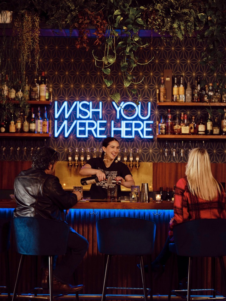 Bartender serving a couple drinks at Decibel Sound & Drink in Milwaukie