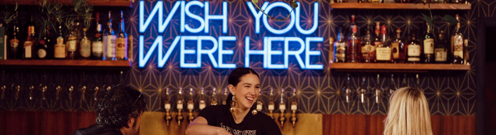Bartender serving a couple drinks at Decibel Sound & Drink in Milwaukie