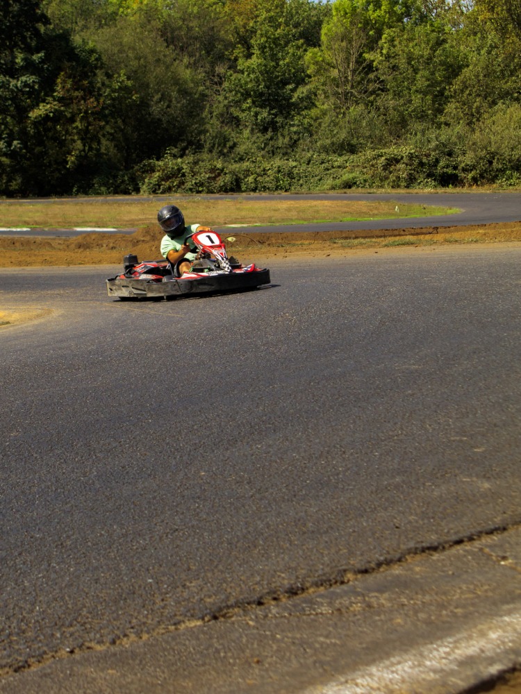 Person racing a go-kart on track