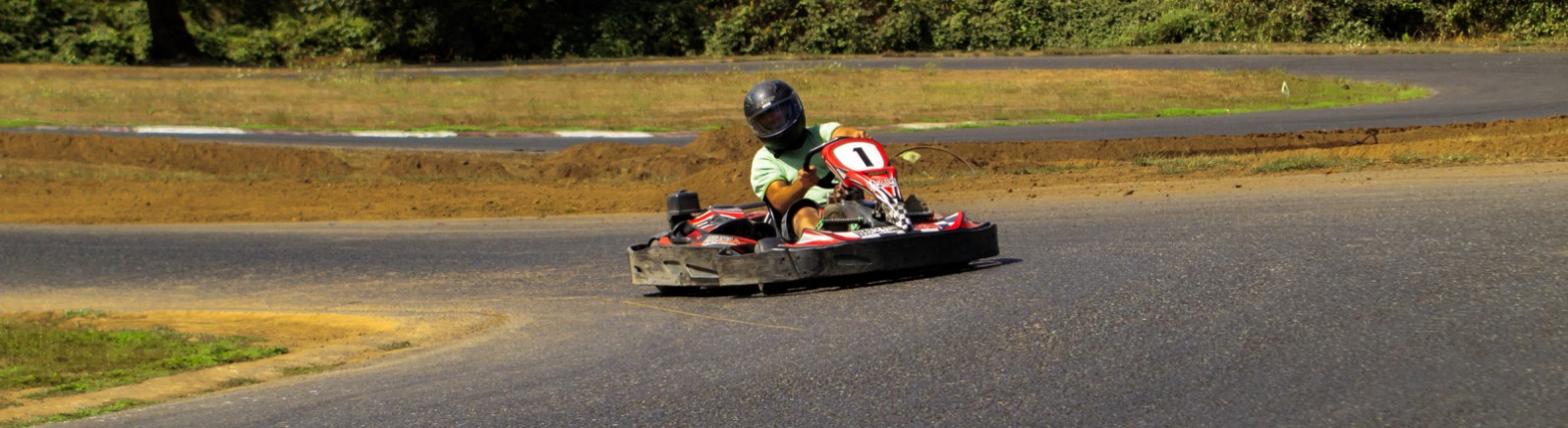 Person racing a go-kart on track
