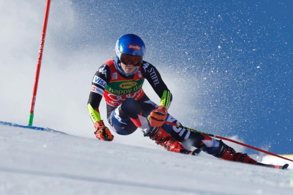 Downhill skiier races around a flag at National Alpine Ski Camp NASC
