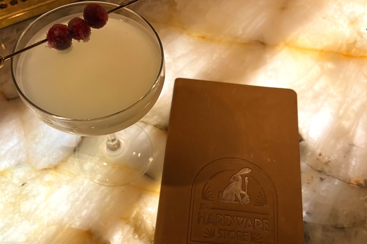 Cocktail and menu on a bar