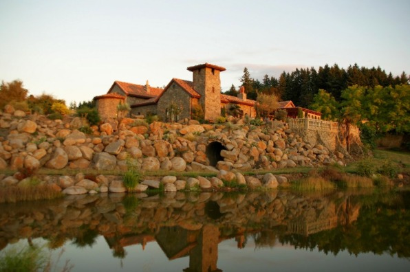 The castle like tasting room at Villa Catalana is reflected in the vineyard pond. 
