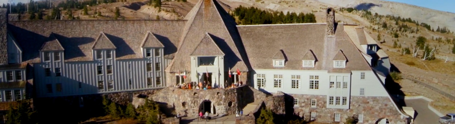 Historic lodge with mountain behind 
