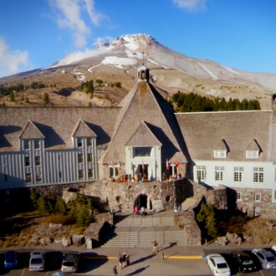 Historic lodge with mountain behind 