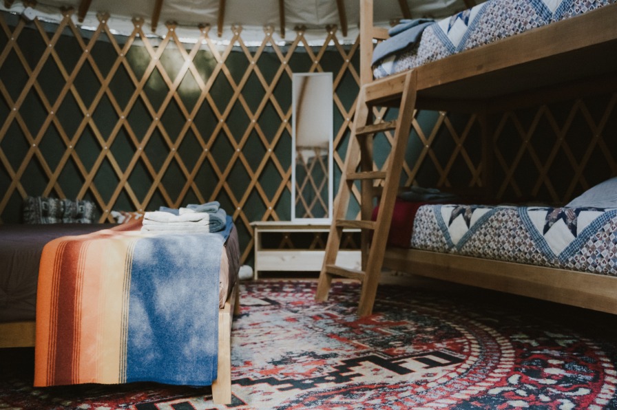 Room with a bed and bunk beds