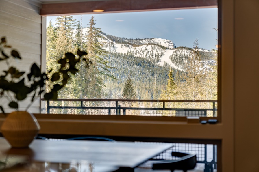 View of snow covered hills from the dining room window at Cozy Luxury Condo in Government Camp.