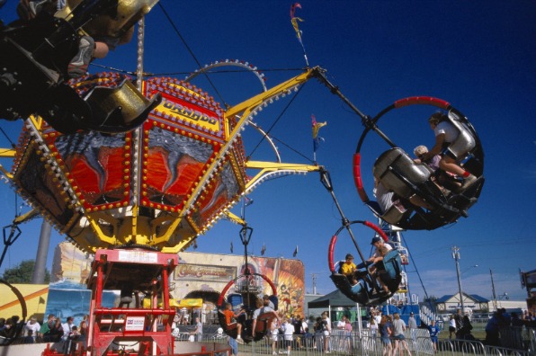 Riders spin on a tornado attraction at the carnival at the Clackamas County Fair