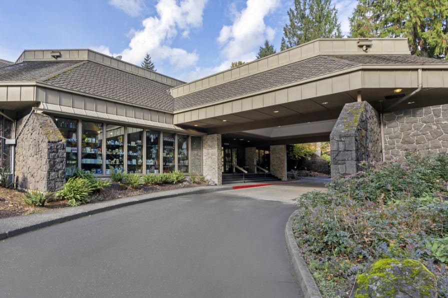 Outside of resort building with green bushes around it.