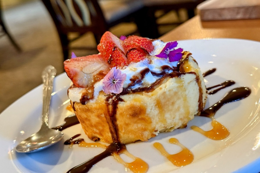 A strawberry cake dessert on a white plate.