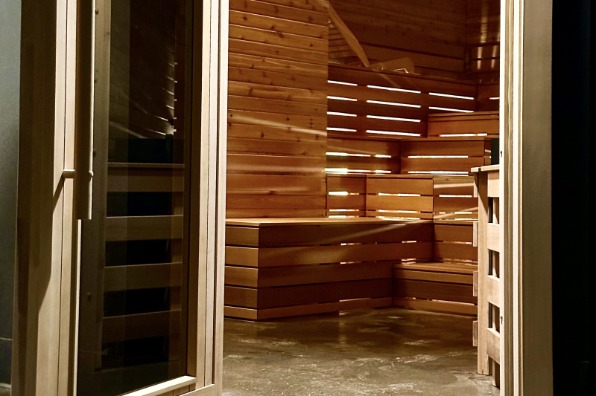 Soft lighting fills the multi-level sauna room at SaunaGlo.