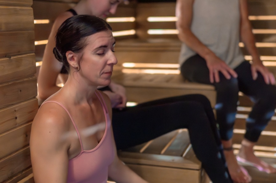 People doing yoga in a sauna