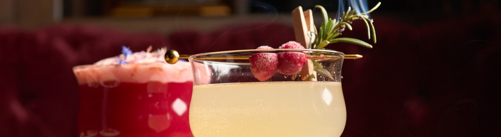 Cocktails on a table with plates of food