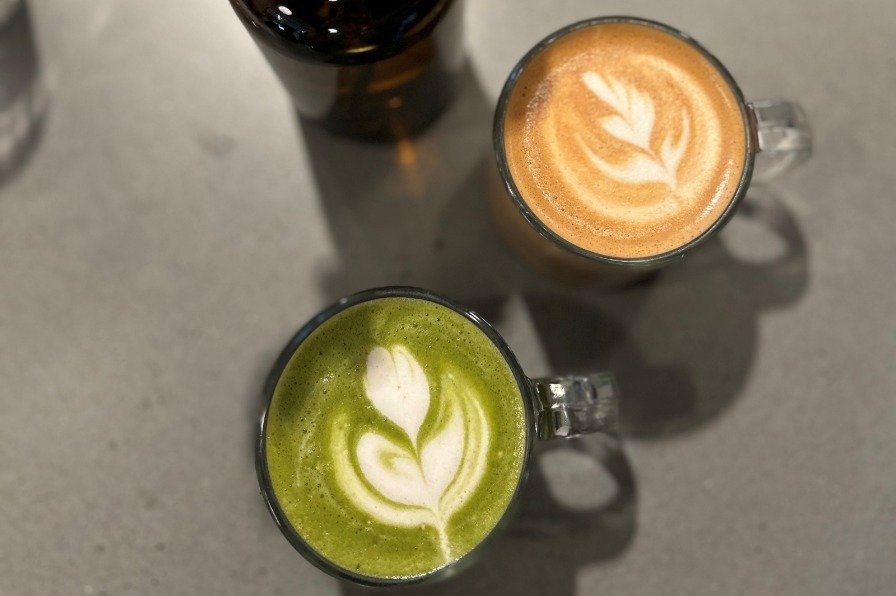 Latte art beside fake flowers