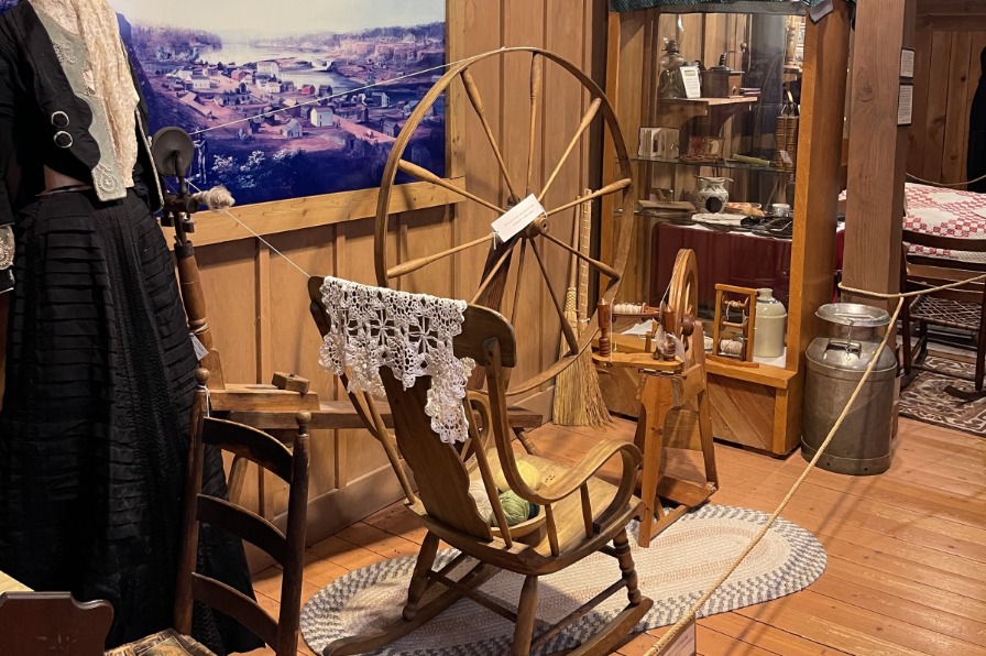 A brown old wool spindle and an old rocking chair
