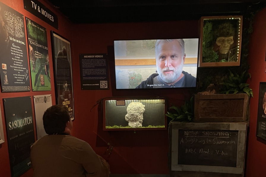 A person watches a Bigfoot show on the TV