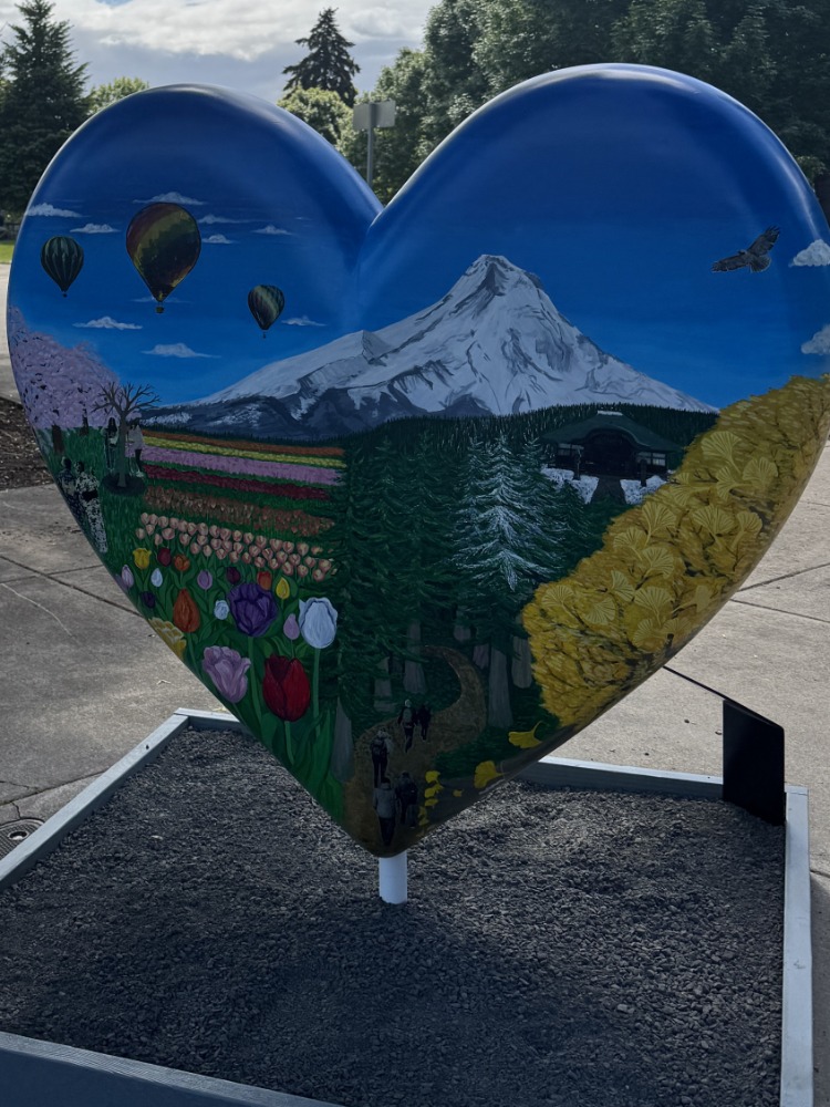 A painted heart sculpture with Mt. Hood on it.
