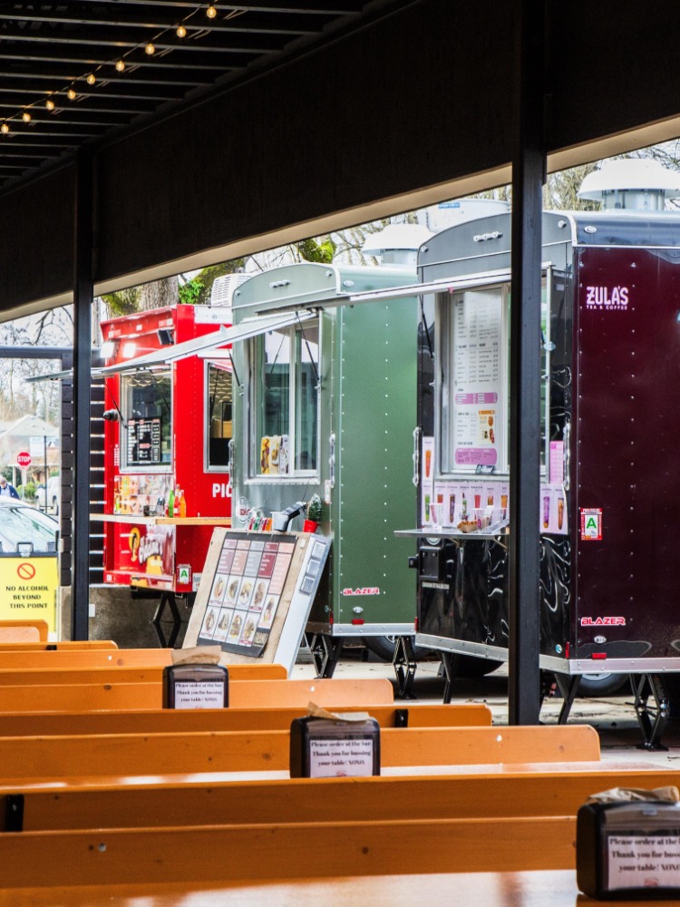 Rows of benches by food trucks
