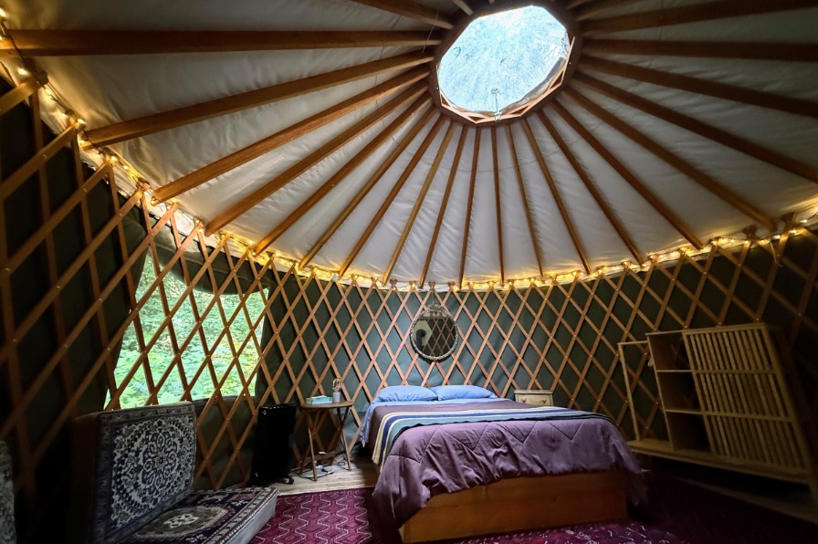 Yurts at Camp Colton A bed sits under a skylight in a yurt