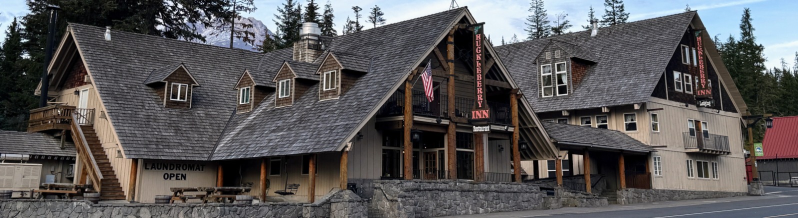 A lodge stands again blue sky with Mt. Hood in the back
