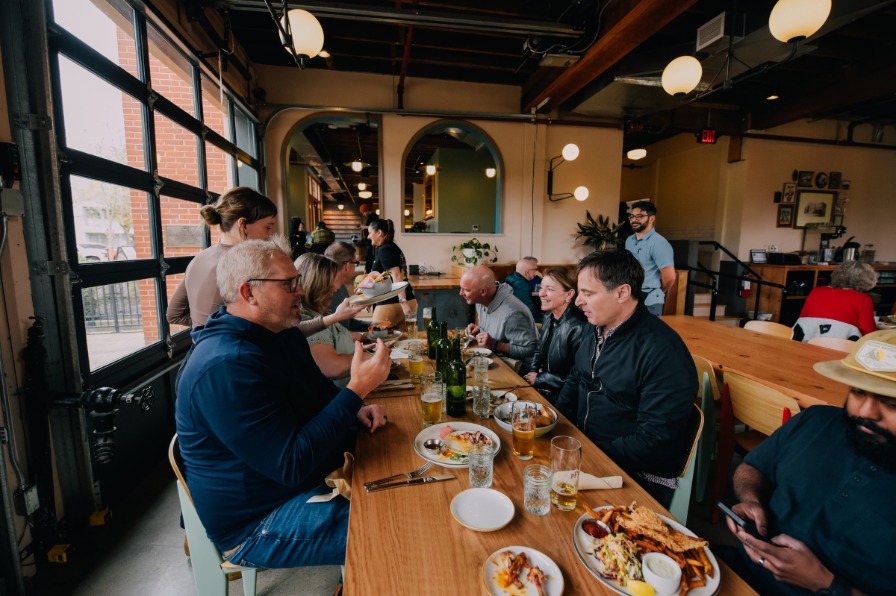 Diners seated at long family style table