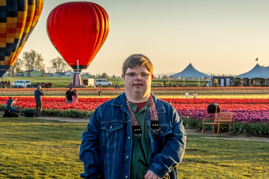 Balloons rise above a visitor to the tulip farm
