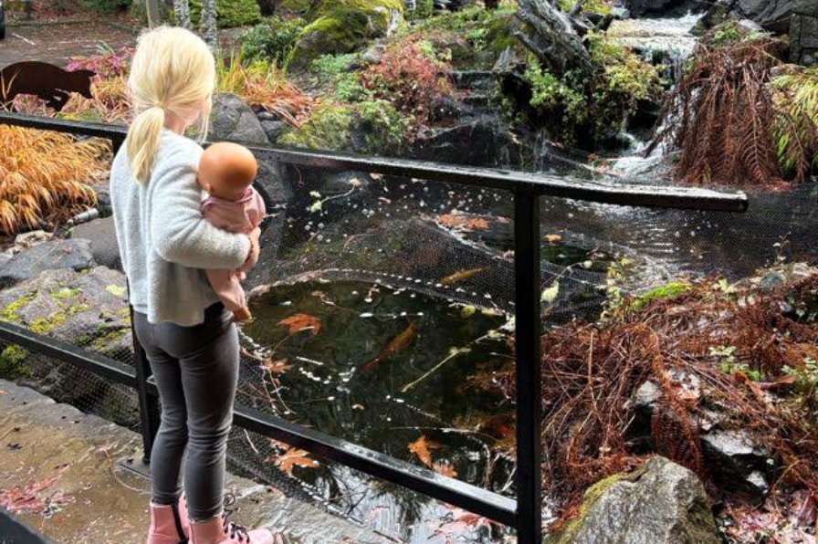 The Mt. Hood Oregon Resort A child looks a pond with green trees around
