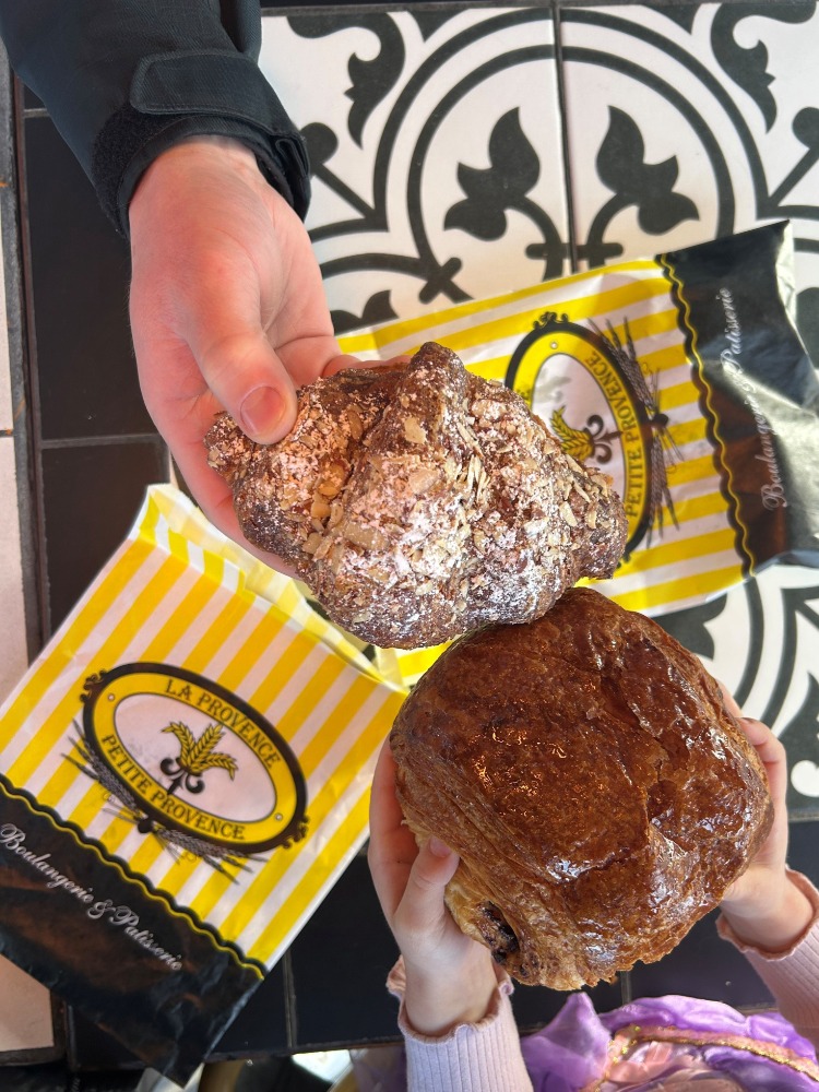 Almond and chocolate croissants on black and white bistro table
