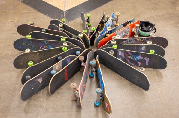 Skateboards laying on their sides form a circle with edges meeting in the middle.