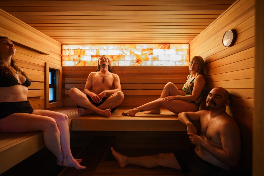 Four people relax in a sauna