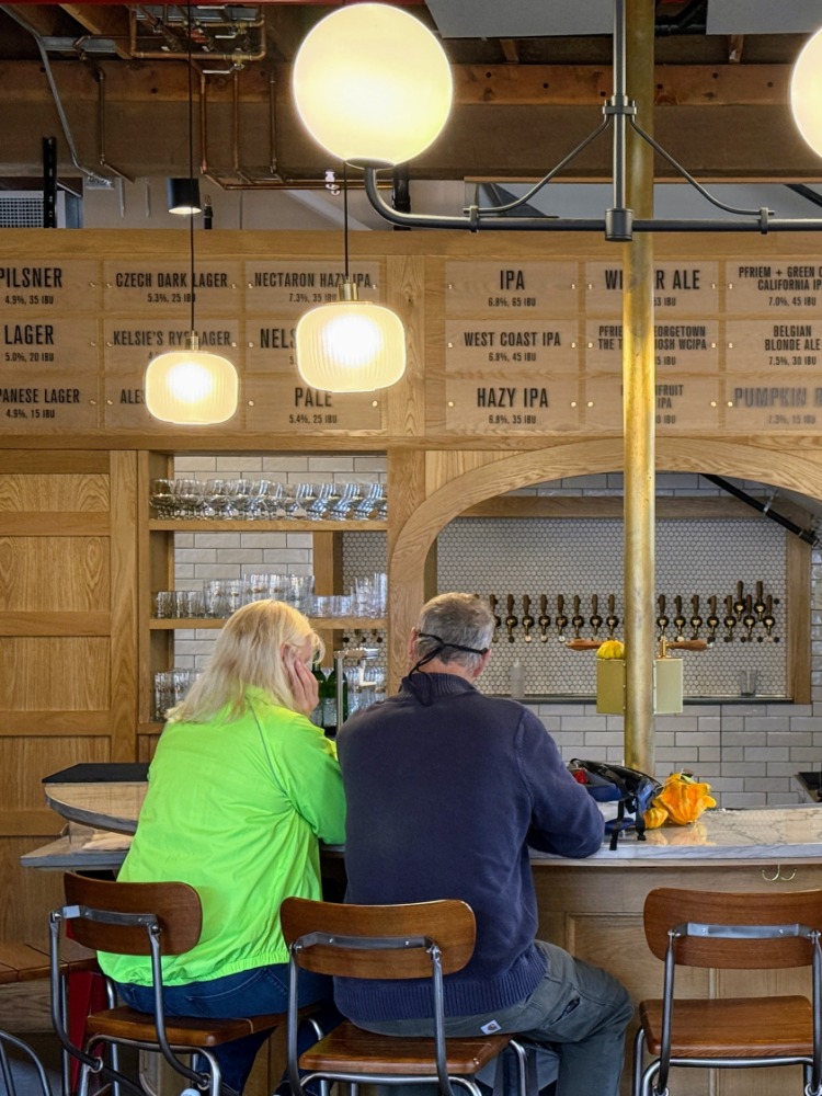 A couple sits at a brewery bar