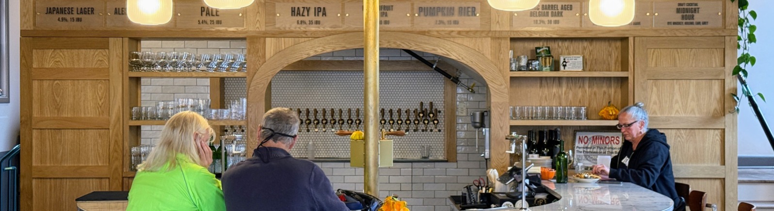 A couple sits at a brewery bar