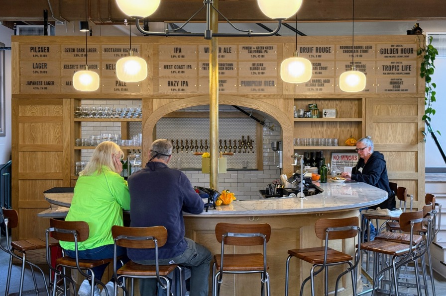 A couple sits at a brewery bar