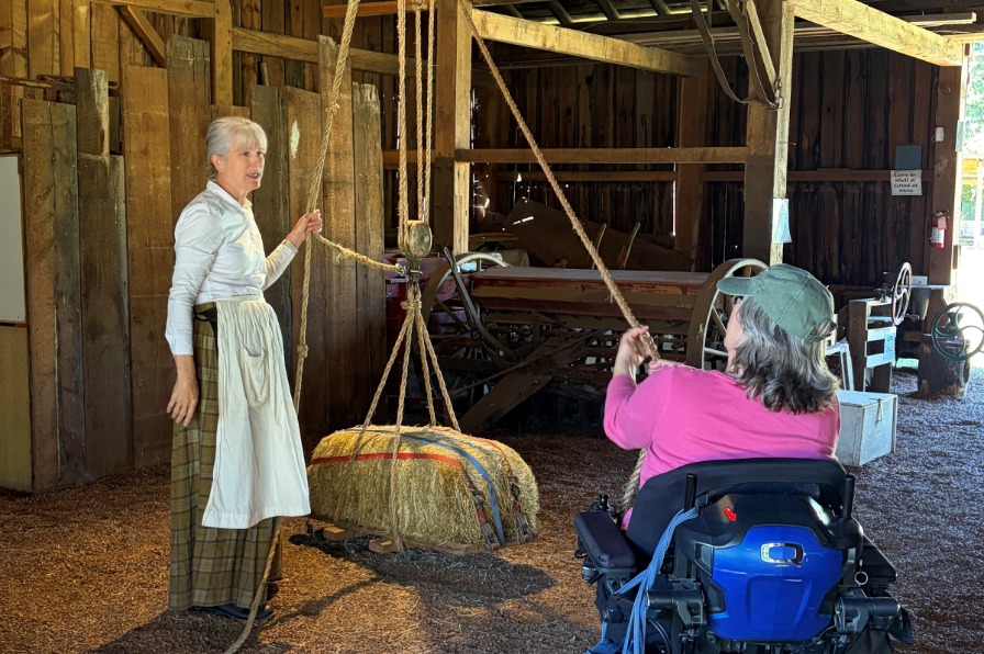 A person in a wheelchair operates a pulley