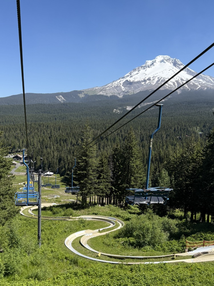 Ski lift above alpine slide with Mt. Hood in background
