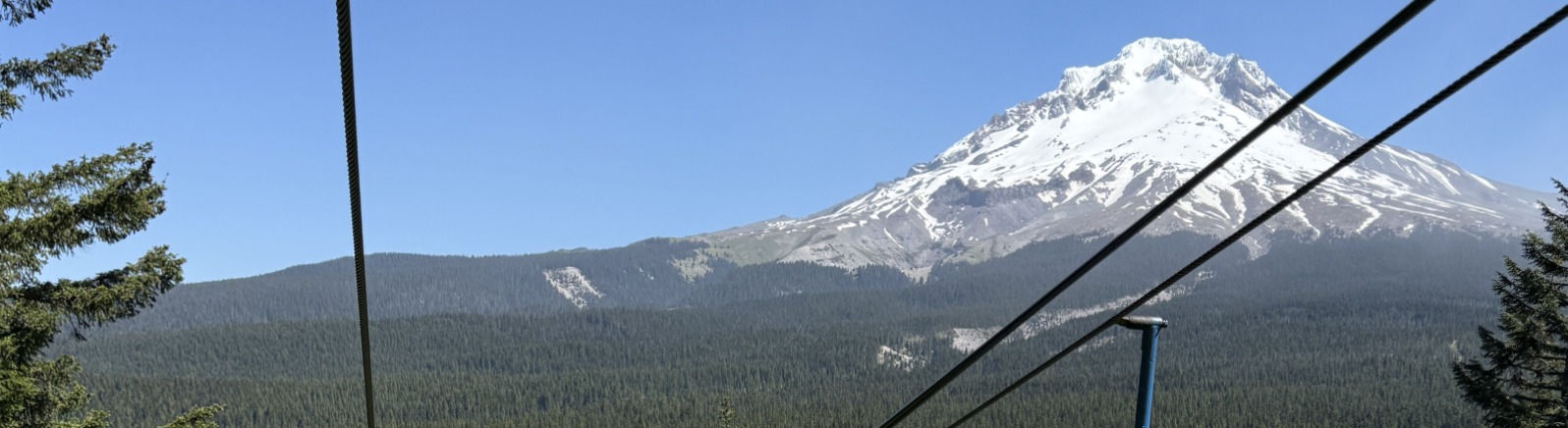 Ski lift above alpine slide with Mt. Hood in background
