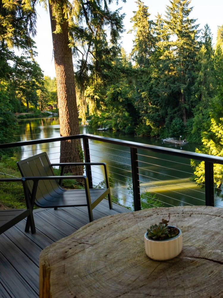 View of river framed in greenery from a patio
