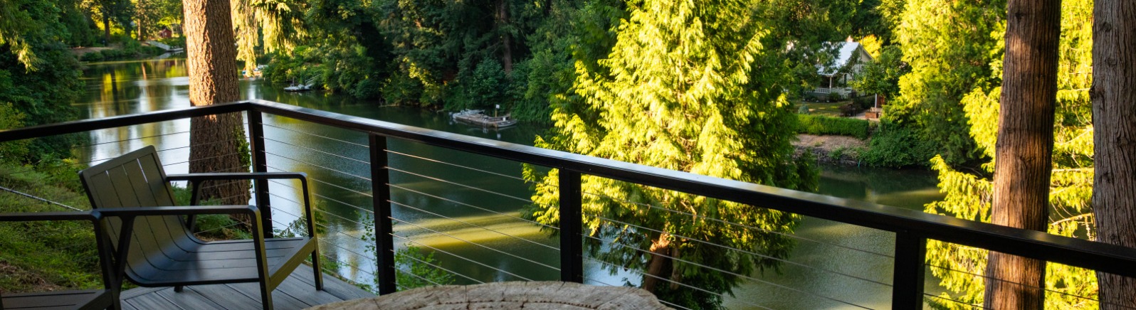 View of river framed in greenery from a patio