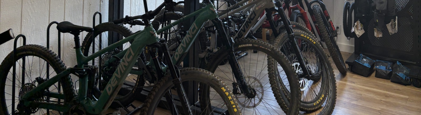 A row of mountain bikes on a wood shelf in a store