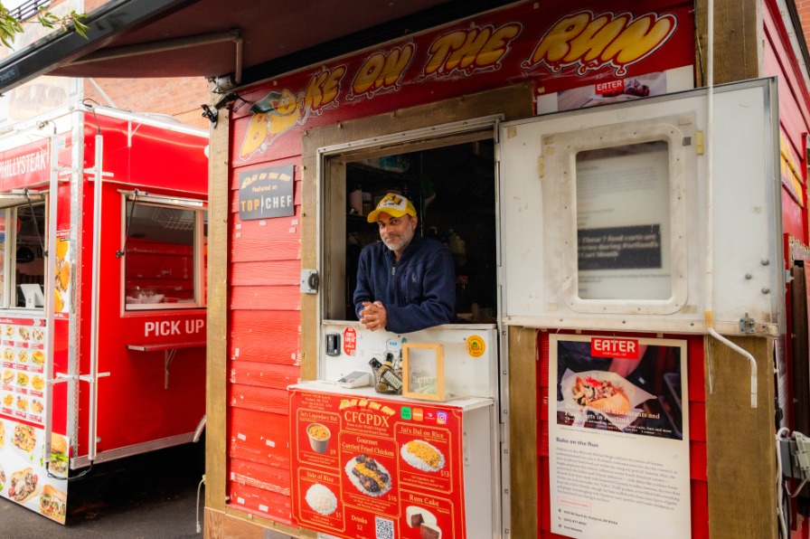 A person looks out of a red food truck