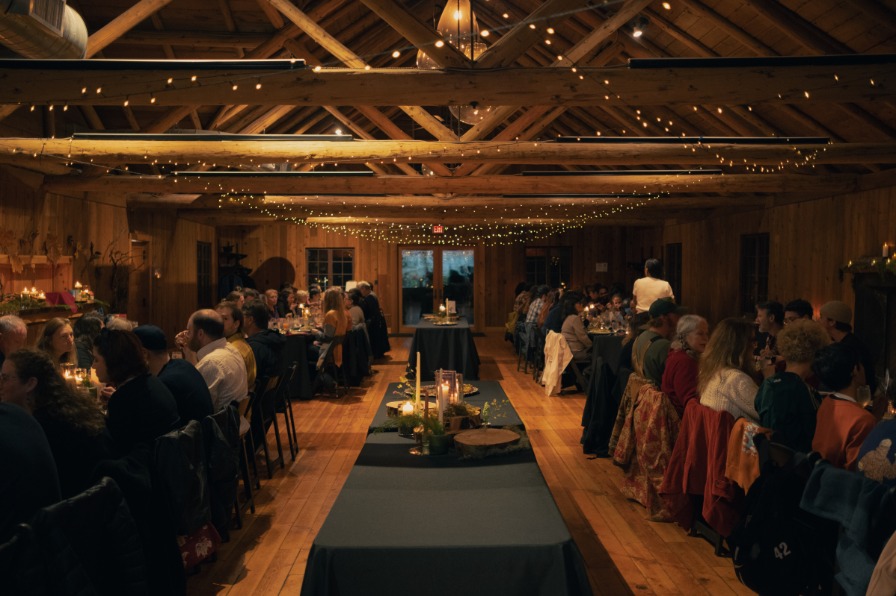 Camp Colton Bigleaf Maple Dinner Tables of people at a fancy dinner in a wood room