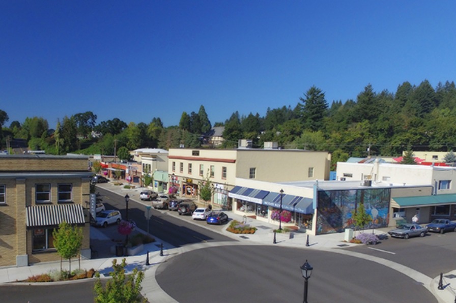 Aerial view of newly completed streetscape of Broadway Street, mural on side of buliding, and downtown Estacada businesses