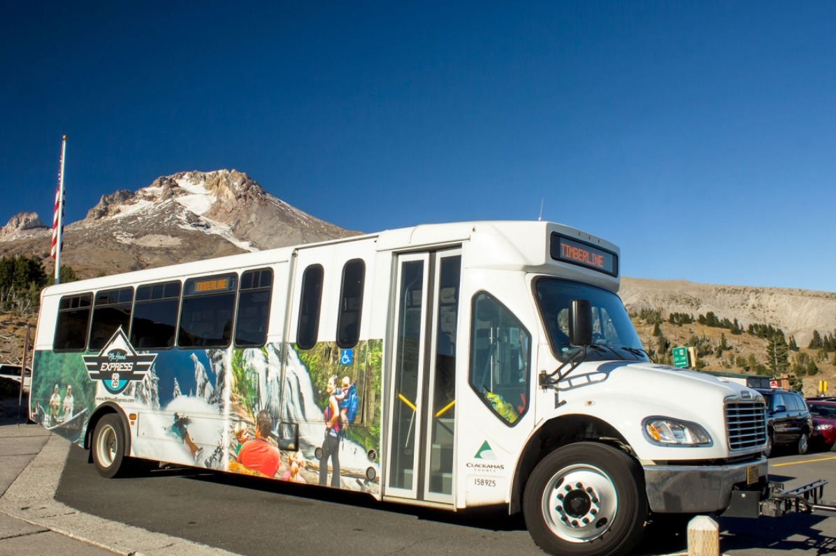 Mt Hood Express Bus in the Timberline Lodge parking lot arriving from Sandy with designated stops along the way