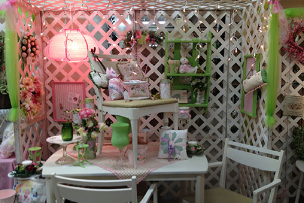 White lattice-backed vendor booth at Spring in the Country Bazaar in Canby features home decor items and other handicrafts